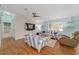 Cozy living room with coastal decor, shiplap accent wall and wood-look floors at 2095 Thornton Ter, The Villages, FL 32162