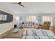 Bright living room features stylish striped furniture and wood-look flooring at 2095 Thornton Ter, The Villages, FL 32162
