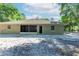 View of backyard, featuring neutral-colored exterior, a screened-in patio, and a well-maintained yard at 2420 Sr 471, Sumterville, FL 33585