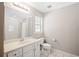 Bright bathroom with vanity, large mirror, and tiled shower/tub combo, creating a clean and functional space at 2420 Sr 471, Sumterville, FL 33585
