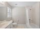 Well-lit bathroom features a shower over tub with tile surround and a large window for natural light at 2420 Sr 471, Sumterville, FL 33585
