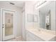 Bright bathroom offers a vanity, updated fixtures and a walk-out access door to the yard at 2420 Sr 471, Sumterville, FL 33585
