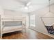 This bedroom features a bunk bed, ceiling fan, wood floors and natural light at 2420 Sr 471, Sumterville, FL 33585