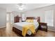 This bedroom features a queen bed, ceiling fan, wood floors and natural light at 2420 Sr 471, Sumterville, FL 33585