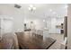 Spacious dining room with wood floors and a view of the kitchen, living room, and entry way at 2420 Sr 471, Sumterville, FL 33585