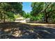 A house situated on a large lot, surrounded by a lush canopy of trees, offering privacy and natural beauty at 2420 Sr 471, Sumterville, FL 33585