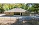 Back exterior view of home with chain-link fence at 2420 Sr 471, Sumterville, FL 33585