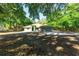 A single Gathering home that features an attached two car garage, green front door and mature surrounding trees at 2420 Sr 471, Sumterville, FL 33585