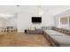 Spacious living room with a large sectional, ceiling fan, and seamlessly connected dining room at 2420 Sr 471, Sumterville, FL 33585