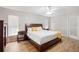 Comfortable main bedroom with hardwood floors, ceiling fan, and bright light from window at 2420 Sr 471, Sumterville, FL 33585