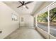 Enclosed patio with a ceiling fan, offering an ideal space for outdoor entertaining and relaxation at 2420 Sr 471, Sumterville, FL 33585