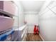 Organized walk-in closet with shelves, hanging rods, and storage bins, offering ample storage at 2420 Sr 471, Sumterville, FL 33585