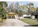 Charming single-story home with attached carport, basketball hoop, and a well-manicured front lawn at 25519 Colmar Ave, Sorrento, FL 32776