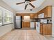 Classic kitchen with wood cabinets, stainless steel refrigerator, and white appliances at 25519 Colmar Ave, Sorrento, FL 32776