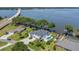 Stunning waterfront home boasts a private pool, lush landscaping, and picturesque lake views at 26516 Savage Cir, Howey In The Hills, FL 34737
