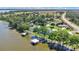 Tranquil lakefront home with private docks and a verdant, tree-lined landscape at 26516 Savage Cir, Howey In The Hills, FL 34737