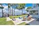 Lakeside backyard featuring a putting green, outdoor kitchen, patio and seating for Gathering and friends at 26516 Savage Cir, Howey In The Hills, FL 34737