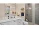 Modern bathroom boasting white vanity with chrome fixtures and a glass enclosed tiled shower at 26516 Savage Cir, Howey In The Hills, FL 34737