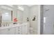 Bathroom features double vanity sinks, marble countertops, and a walk-in shower with tile surround at 26516 Savage Cir, Howey In The Hills, FL 34737
