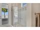 Stylish bathroom featuring a glass shower and beautiful waterfront view at 26516 Savage Cir, Howey In The Hills, FL 34737