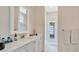 Bathroom showing white cabinets, marble countertop, and shower at 26516 Savage Cir, Howey In The Hills, FL 34737