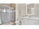Bathroom with a glass enclosed shower, gray tiling and white cabinets at 26516 Savage Cir, Howey In The Hills, FL 34737