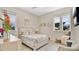 Bright bedroom featuring three windows and a floral themed bed set at 26516 Savage Cir, Howey In The Hills, FL 34737