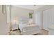 Bright bedroom features a wooden bed frame, light wood floors, and white walls at 26516 Savage Cir, Howey In The Hills, FL 34737