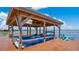 Covered boat lift with a sleek blue boat, offering the perfect lakeside experience at 26516 Savage Cir, Howey In The Hills, FL 34737
