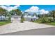 Inviting two-story home with a paver driveway, lush landscaping, and a detached two car garage at 26516 Savage Cir, Howey In The Hills, FL 34737