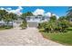 Beautiful two-story home with a long brick driveway and a three-car garage at 26516 Savage Cir, Howey In The Hills, FL 34737