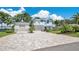 Beautiful two-story home with a long brick driveway and a three-car garage at 26516 Savage Cir, Howey In The Hills, FL 34737