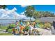 Inviting fire pit with chairs, surrounded by lush greenery and views of the serene lake at 26516 Savage Cir, Howey In The Hills, FL 34737