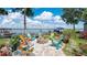 Cozy outdoor fire pit area with colorful Adirondack chairs and beautiful lake views at 26516 Savage Cir, Howey In The Hills, FL 34737