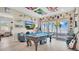 Spacious game room boasting a pool table, waterfront view, and unique decor at 26516 Savage Cir, Howey In The Hills, FL 34737