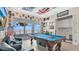 Entertaining game room with a pool table, eclectic decor, and water view at 26516 Savage Cir, Howey In The Hills, FL 34737