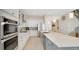 Open kitchen with stainless steel appliances, a large island with a sink, and ample counter space at 26516 Savage Cir, Howey In The Hills, FL 34737