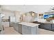 Spacious open kitchen and living area with stainless steel appliances and modern finishes at 26516 Savage Cir, Howey In The Hills, FL 34737