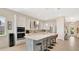 Bright kitchen features a large island with seating, stainless steel appliances, and custom white cabinetry at 26516 Savage Cir, Howey In The Hills, FL 34737
