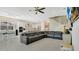 Open-concept living area with modern finishes, a large sectional, and easy access to the kitchen at 26516 Savage Cir, Howey In The Hills, FL 34737