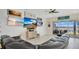 Modern living room with a large sectional sofa and multiple TVs for entertainment at 26516 Savage Cir, Howey In The Hills, FL 34737