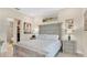 Cozy main bedroom with a large bed, neutral tones, and a glimpse of the walk-in closet at 26516 Savage Cir, Howey In The Hills, FL 34737