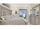 Main bedroom with a view, gray furniture, and a sliding door at 26516 Savage Cir, Howey In The Hills, FL 34737