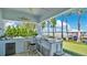 Outdoor kitchen with premium grill and lake views at 26516 Savage Cir, Howey In The Hills, FL 34737