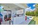 Outdoor kitchen featuring a built-in grill, granite countertop, and entertainment space with a view of the lush backyard at 26516 Savage Cir, Howey In The Hills, FL 34737