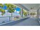Covered patio with view of lake, boat dock and a ceiling fan at 26516 Savage Cir, Howey In The Hills, FL 34737