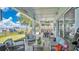 Inviting covered patio with comfortable seating and stunning waterfront views with a well-equipped outdoor kitchen at 26516 Savage Cir, Howey In The Hills, FL 34737