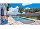 Beautiful backyard pool area with comfortable lounge chairs and serene waterfront views at 26516 Savage Cir, Howey In The Hills, FL 34737