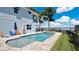 Backyard featuring a swimming pool, spa, landscaping, and a view of the lake at 26516 Savage Cir, Howey In The Hills, FL 34737