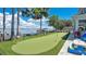 Lush backyard featuring a putting green and beautiful lakeside view at 26516 Savage Cir, Howey In The Hills, FL 34737